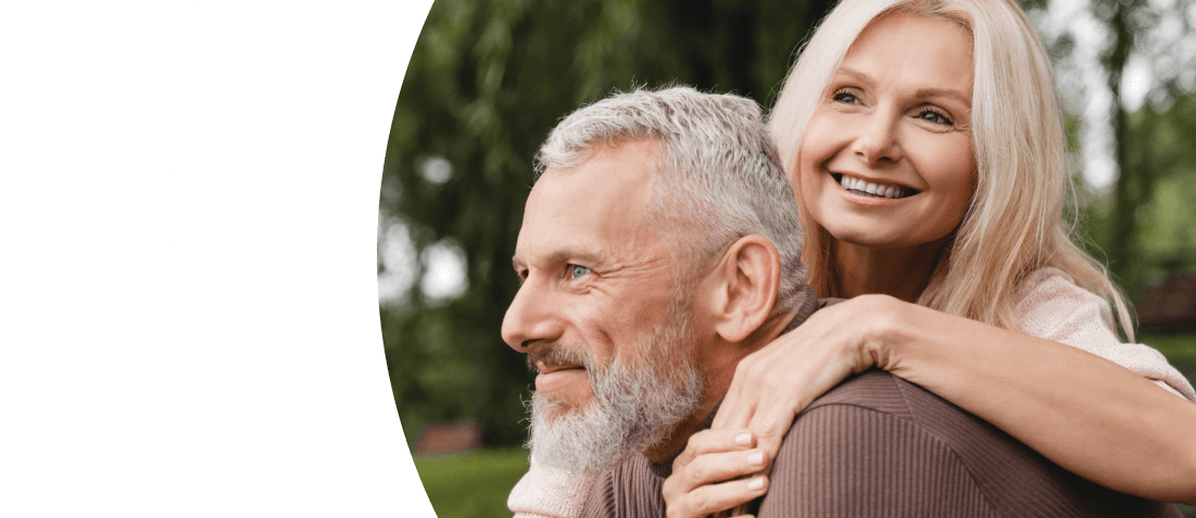 A smiling woman hugging a smiling man